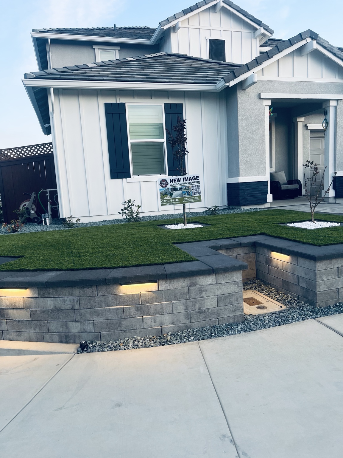 Front-yard landscape with decorative rock and wall