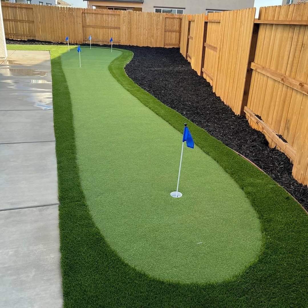 A compact putting green brings a playful, tailored feature to the backyard.