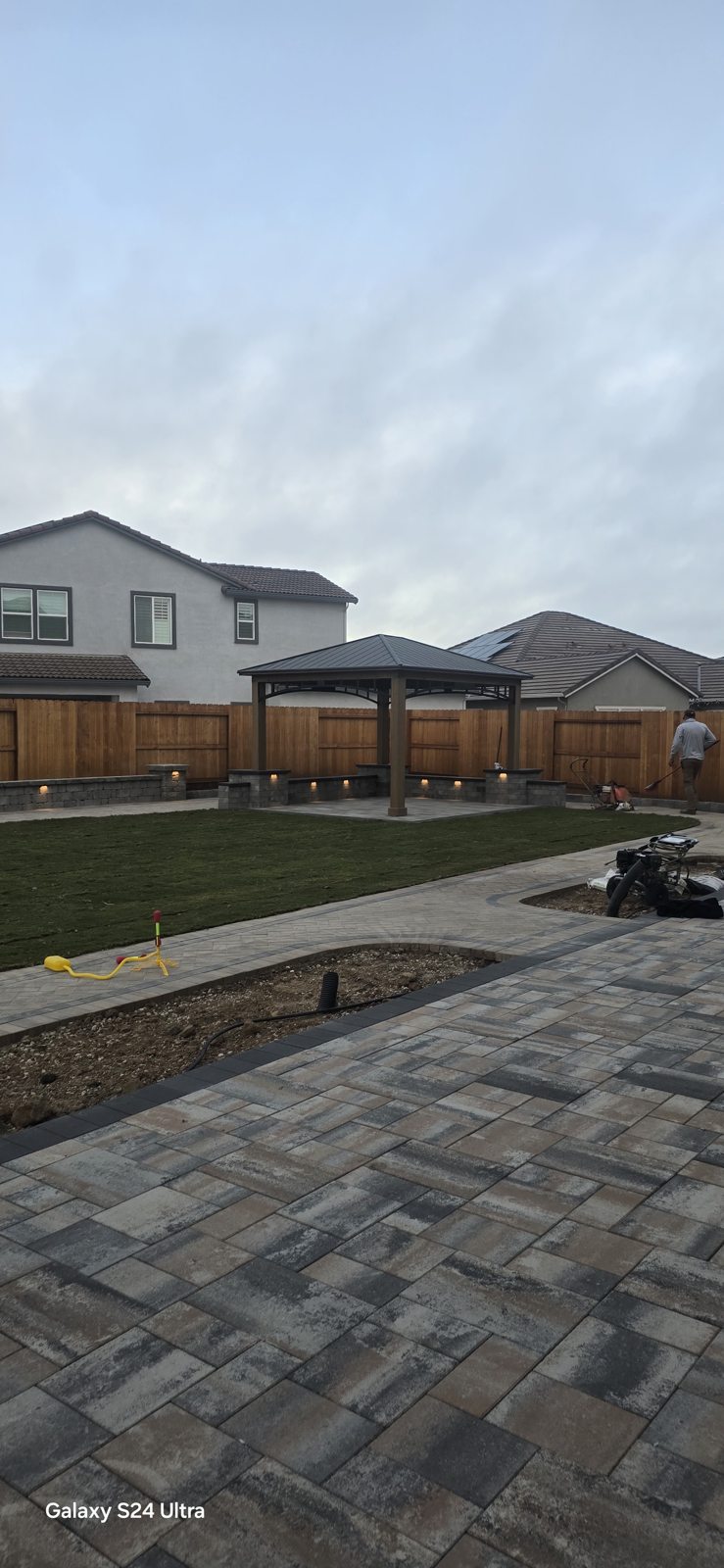 A broad paver terrace creates room to relax beside the garden.