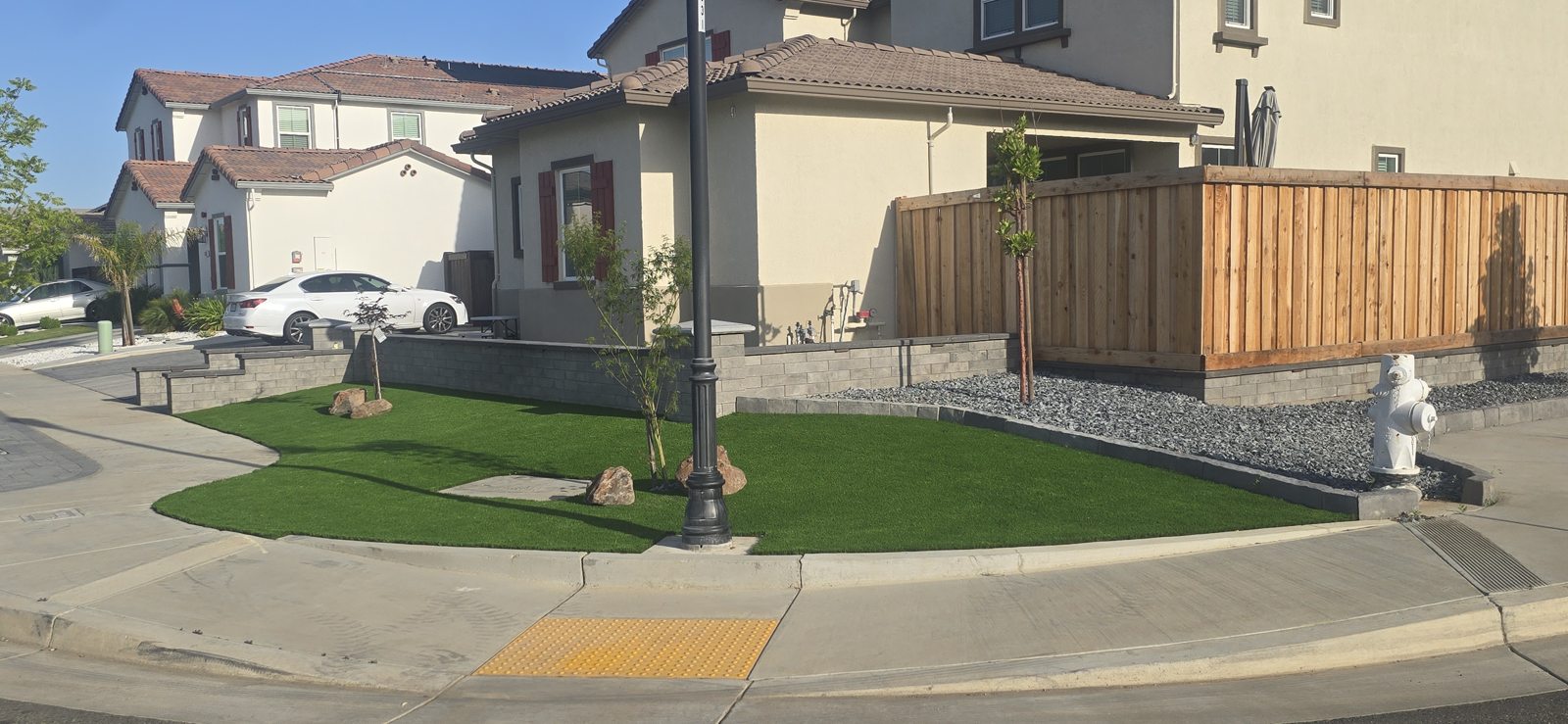 The raised lawn follows a graceful curve around the front of the property.