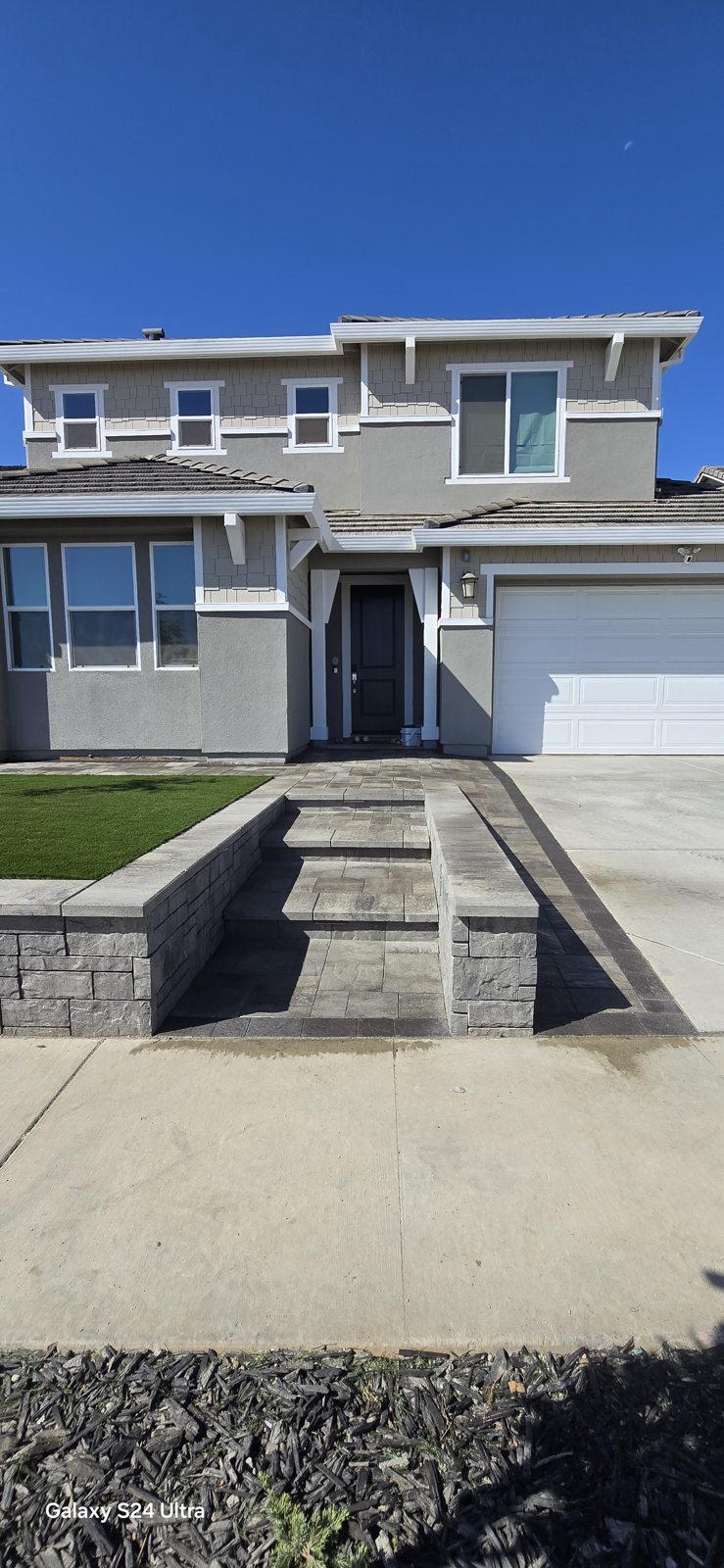 Layered walls and steps organize the raised front landscape.