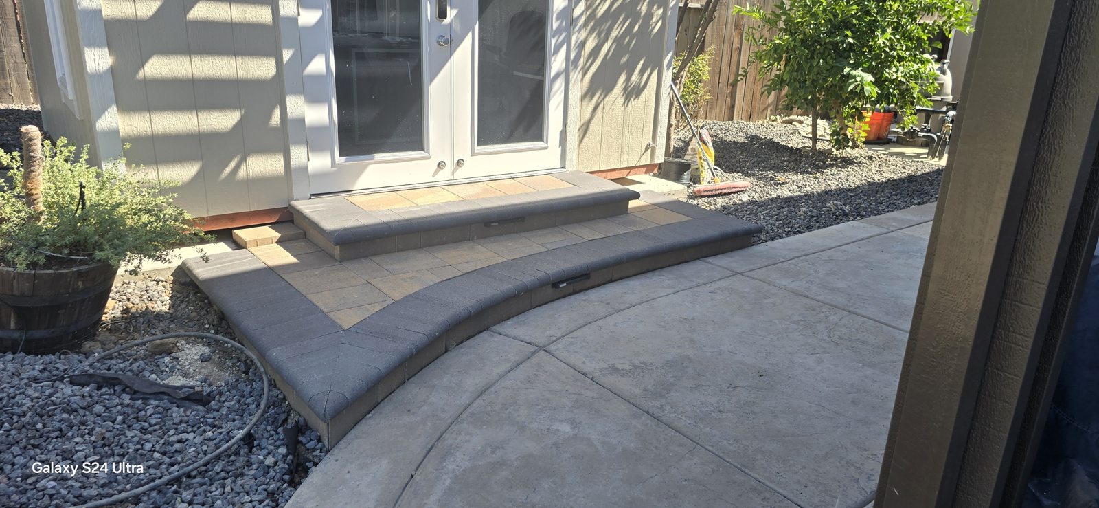 A curved step follows the porch edge for a gentle transition to the walkway.