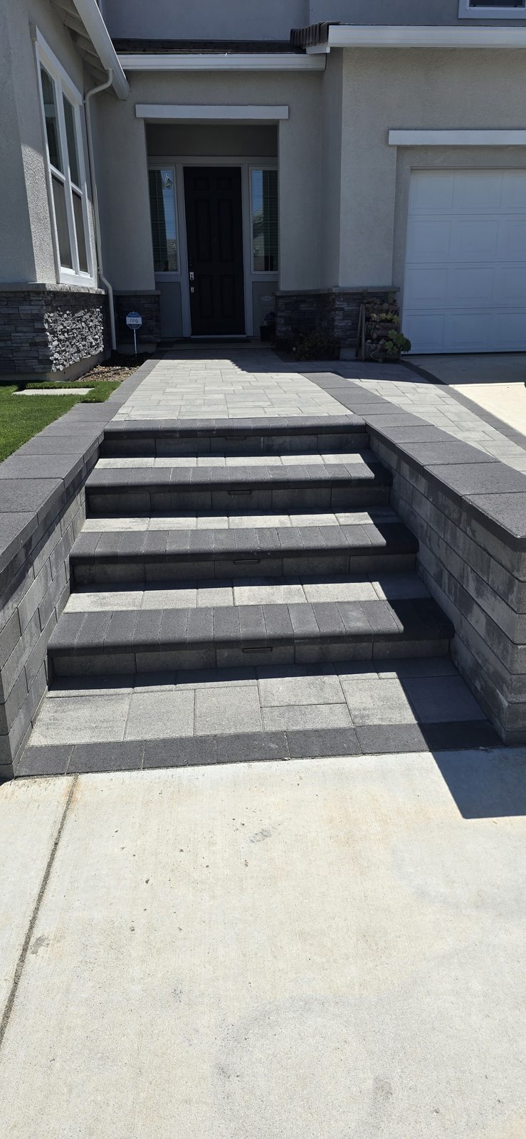 Broad gray steps create a clear, elegant route toward the front door.