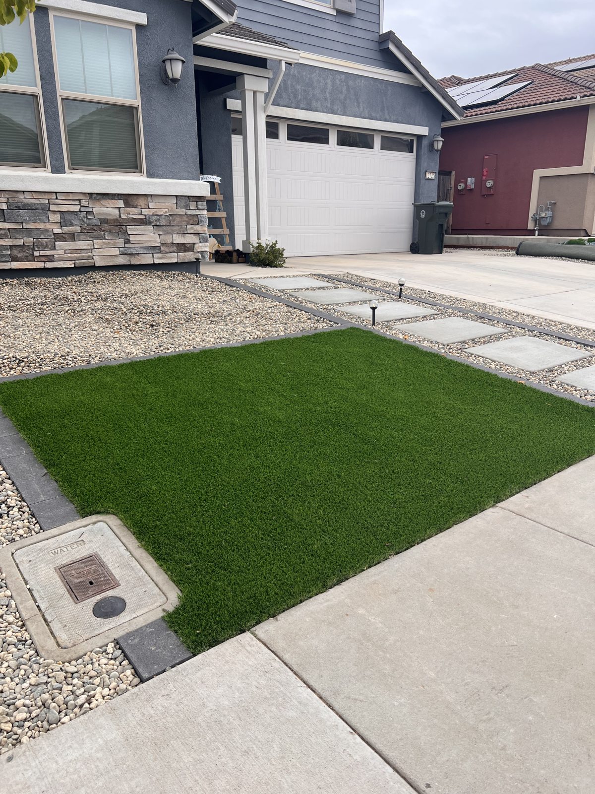 A compact green area fits neatly between the paved surfaces and the home.