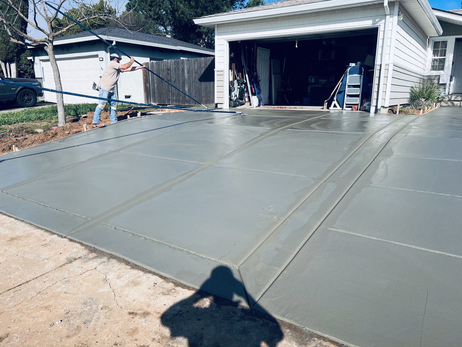 A broad concrete patio creates an adaptable foundation for outdoor living.