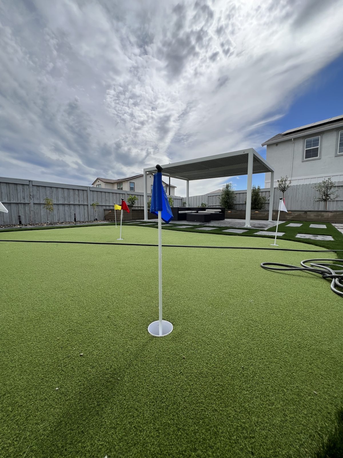 A putting-green detail creates a dedicated space for practice and outdoor leisure.