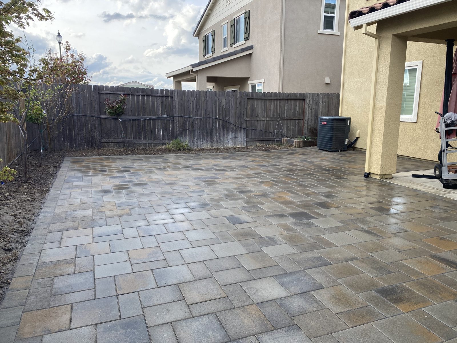 Warm pavers extend the living space from the house into the garden.