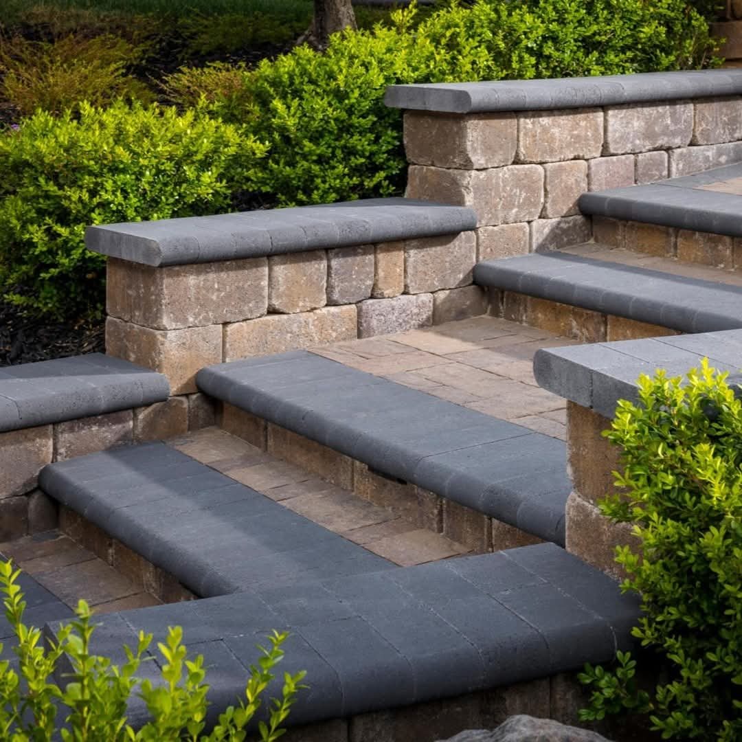 Broad garden steps nestle between stone walls and established planting.