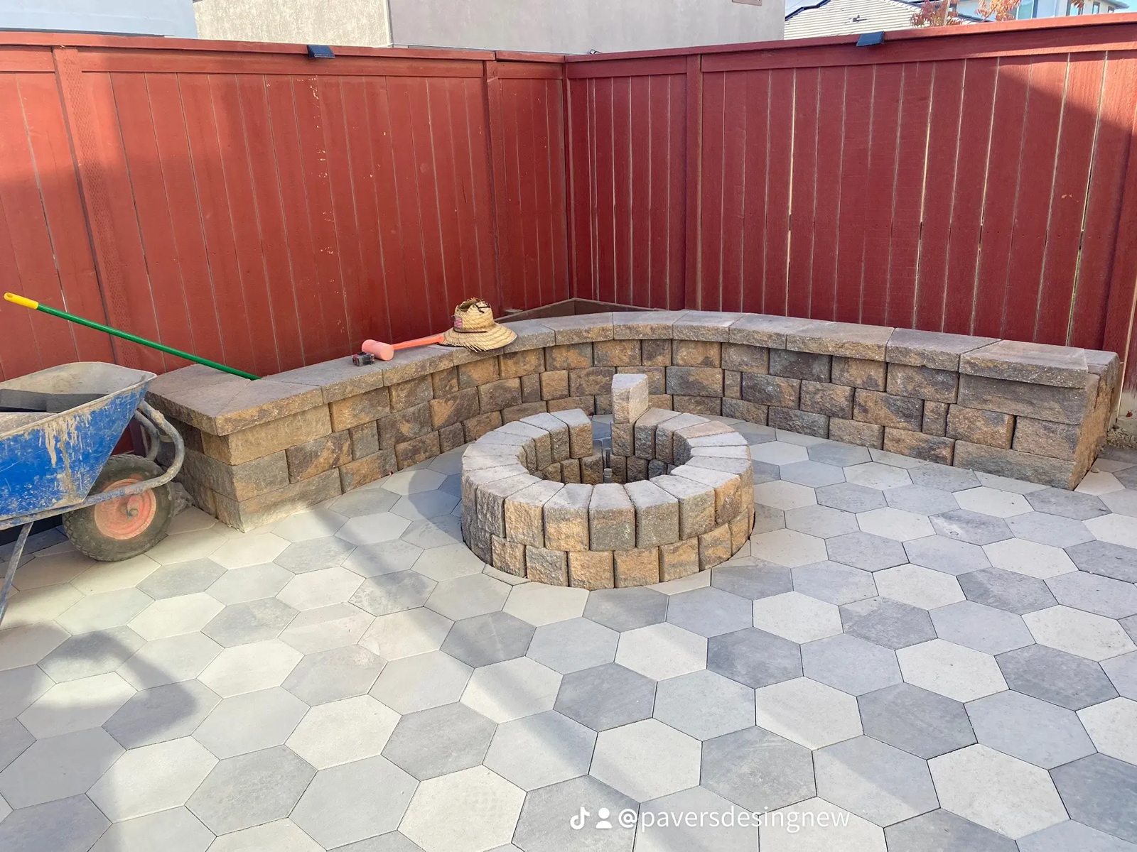 A circular fire-pit setting and integrated seating anchor this patterned patio.
