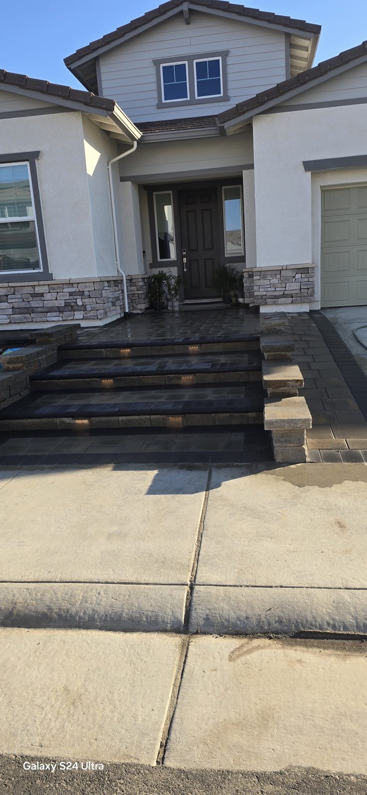 A broad stepped entrance gives the front approach depth and visual balance.