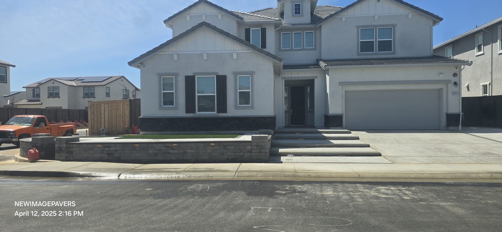 Low walls and broad entry steps frame the front of the home.