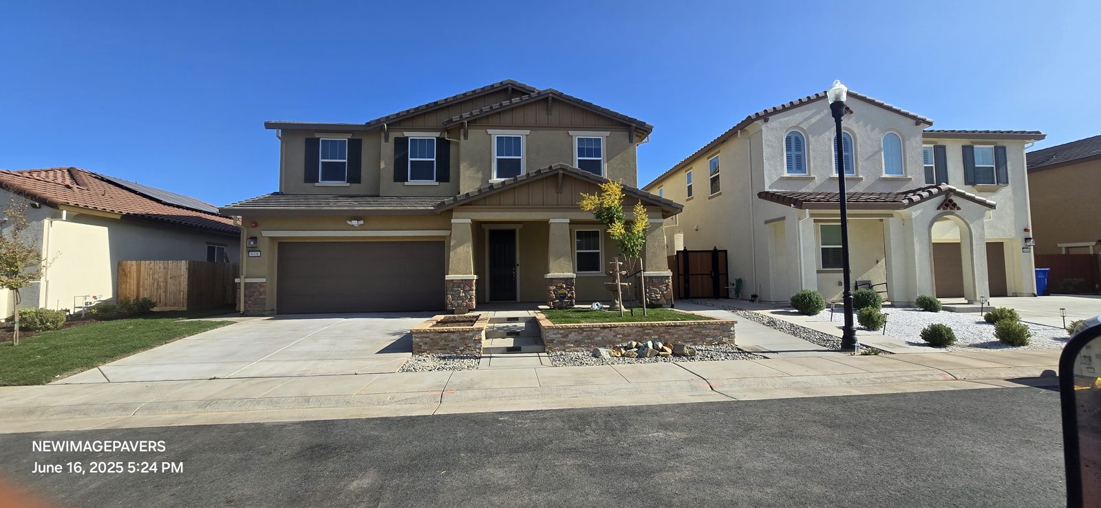 A broad street view brings together the home, entry steps and landscaped frontage.