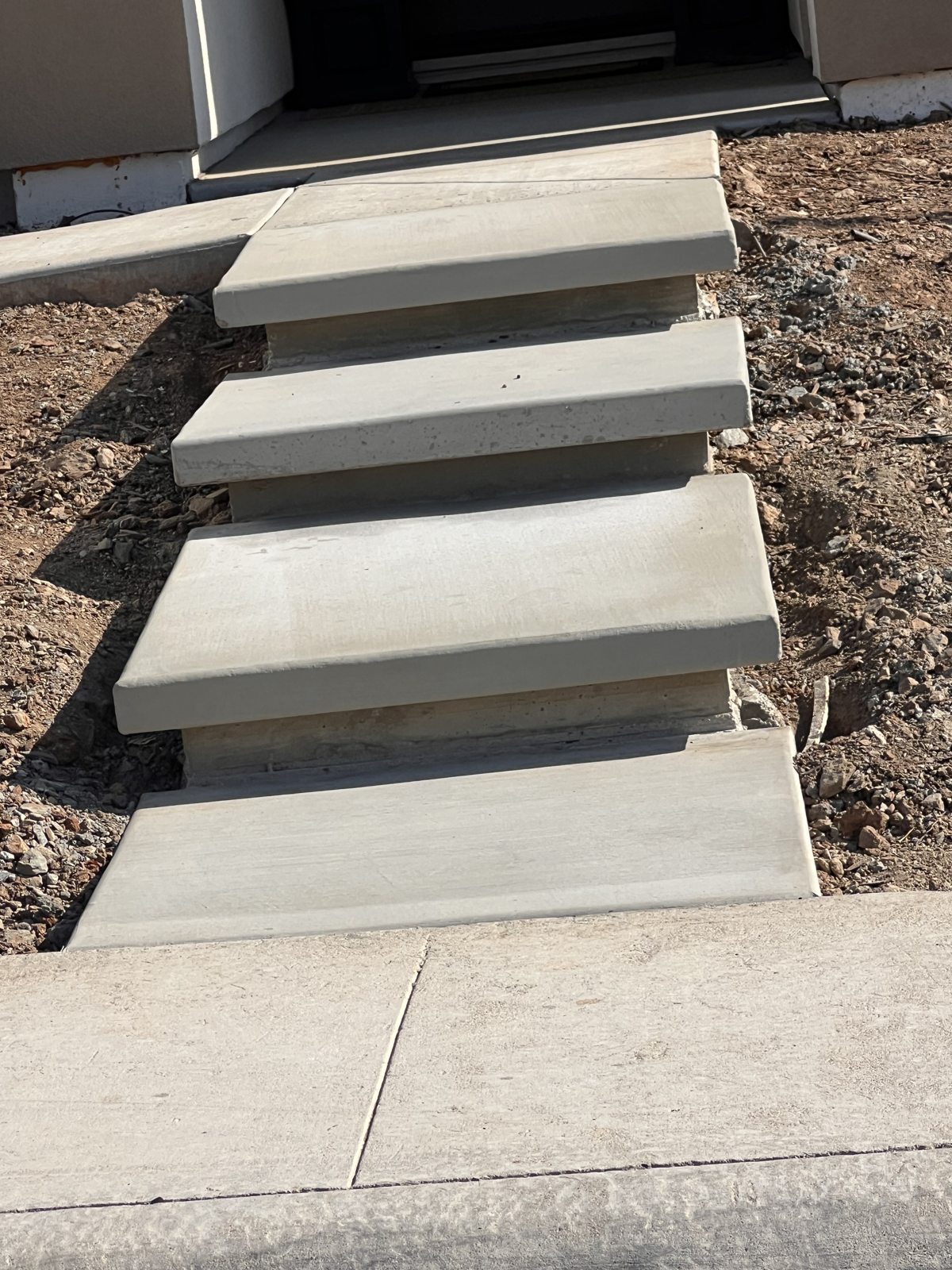 Floating-style concrete steps create a simple, contemporary entry sequence.