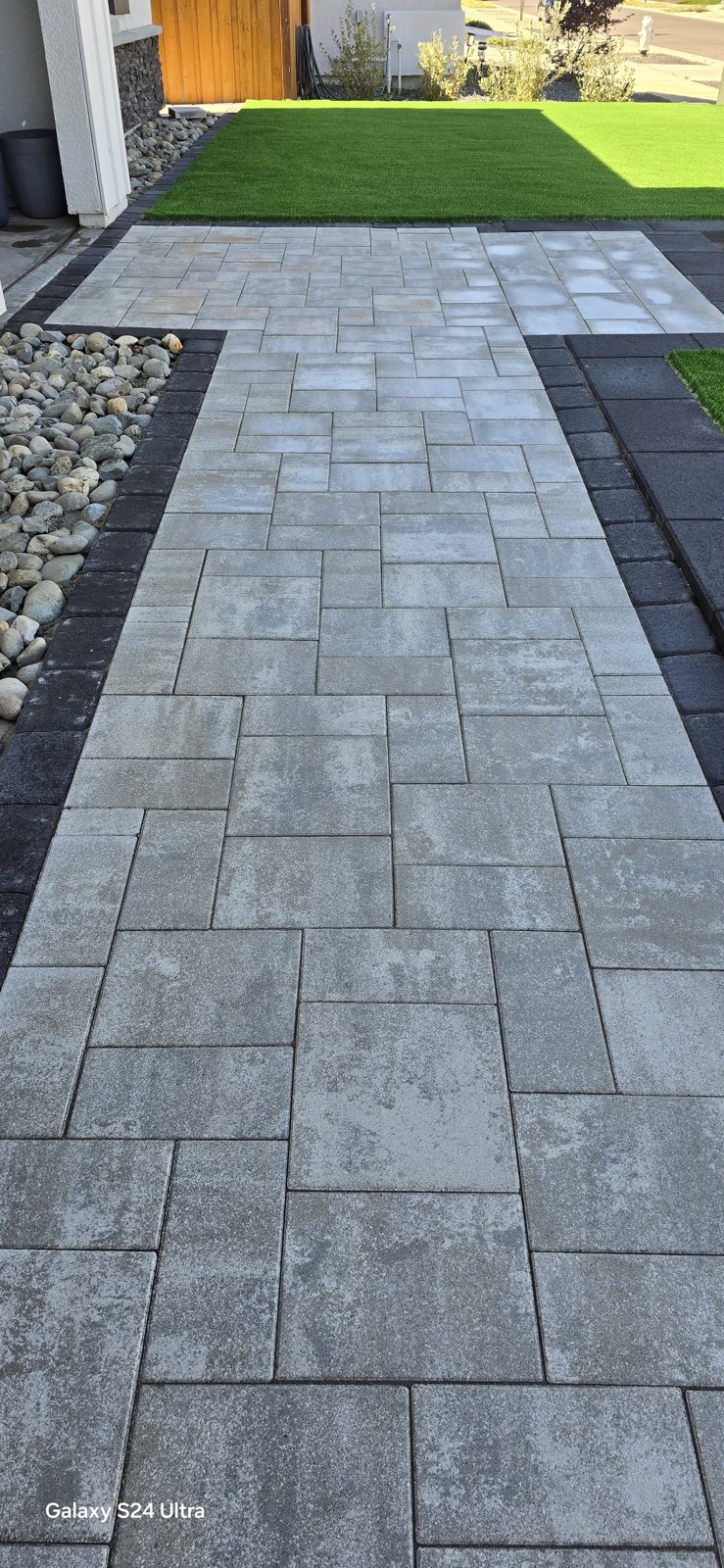 A contrasting paver border gives this entrance a precise, tailored finish.