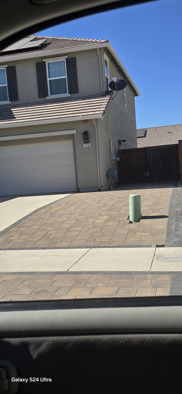 Wide entry steps connect the driveway with the front of the home.
