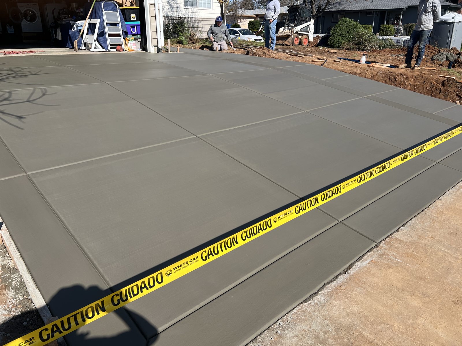 A newly finished concrete surface opens up a generous outdoor area.