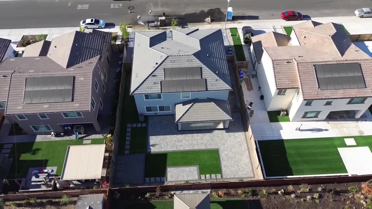 An aerial perspective brings the front landscape, driveway and backyard into one view.